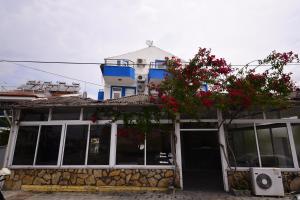 a building with red flowers on top of it at Fethiye Apart Otel in Fethiye