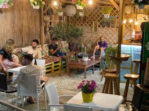 a group of people sitting at tables in a room at Vlora Backpackers Hostel & Bar LUNGOMARE in Vlorë