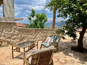 a patio with two chairs and a coffee table at The Artist's Lodge, GcollectionGr in Kranidi