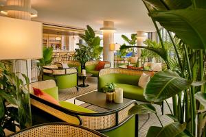 a lobby with green furniture and plants at Hotel Indigo - Williamsburg - Brooklyn, an IHG Hotel in Brooklyn