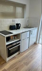 a kitchen with a sink and a counter top at Perfect stay with Dallas Studio in Hayes