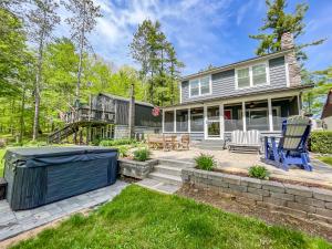 an exterior view of a house with a patio at Adorable Lakefront Cottage with Hot Tub and Dock Pet friendly in Swanton