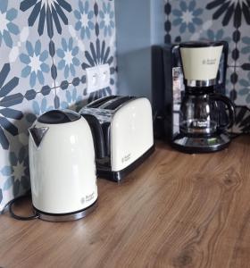 two toasters and a coffee maker on a counter at Apartamenty Parkowe D9 in Oświęcim