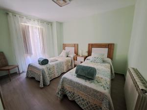 Habitación con 3 camas y ventana en EL CHORRITO en La Alberca