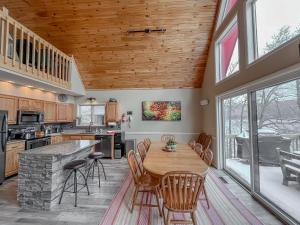 a kitchen with a wooden ceiling and a table and chairs at Central Lake House with Private Dock Walk to Area Hot Spots in Oakland