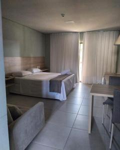 a hotel room with a bed and a table and a bed sidx sidx at Villas BobZ Apt.109 in Barra Grande