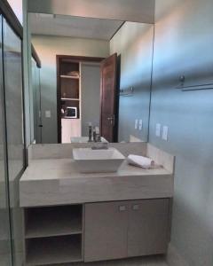 a bathroom with a sink and a large mirror at Villas BobZ Apt.109 in Barra Grande