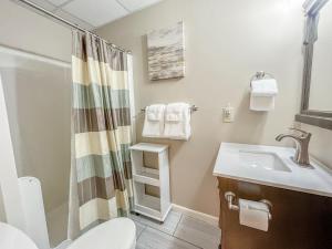 a bathroom with a sink and a toilet and a shower at Central Lake House with Private Dock Walk to Area Hot Spots in Oakland +41 photos