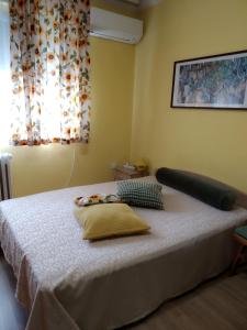 a bed with two pillows on it in a bedroom at Maria Louisa Apartment in Sofia