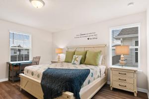 a bedroom with a bed and a desk and windows at Luxury Six Bed Four in Bath Windsor Island BSV1707 in Davenport