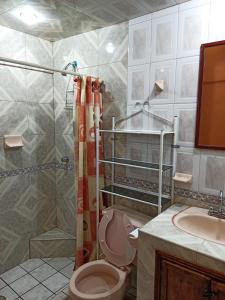 a bathroom with a toilet and a shower and a sink at Casa Granada Jilotepec in Jilotepec