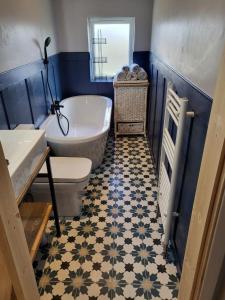 a bathroom with a tub and a toilet and a sink at Trinity apartments n56 in Peterhead