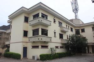 an apartment building with a tower in the background at Carlson Hotel, Osborne Foreshore Phase 2, Ikoyi in Lagos