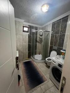 a bathroom with a shower and a toilet and a sink at Relaxable Apartment in Eyüp sultan in Istanbul