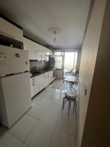 a kitchen with a refrigerator and a table in it at Relaxable Apartment in Eyüp sultan in Istanbul