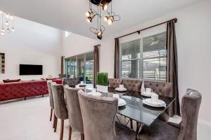 a dining room with a table and chairs at BSV1529 - Luxury 7 Bedroom 5 Bathroom Villa in the Desirable Solara Resort in Kissimmee