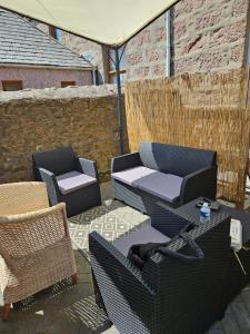 a patio with two chairs and a table and a umbrella at Trinity apartments n56 in Peterhead
