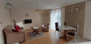 a living room with a table and chairs and a dining room at Apartmani Diva in Malinska