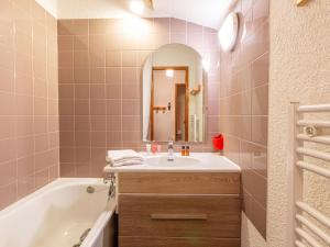 a bathroom with a sink and a tub and a mirror at Appartement Val-d'Isère, 3 pièces, 5 personnes - FR-1-694-254 in Val-d'Isère