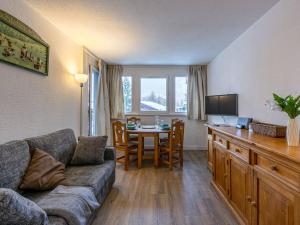 a living room with a couch and a table at Appartement skis aux pieds avec parking couvert et WiFi au cœur de Val d'Isère - FR-1-694-259 in Val dʼIsère