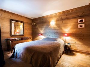 a bedroom with wooden walls and a bed with two lamps at Appartement Val-d'Isère, 4 pièces, 8 personnes - FR-1-694-307 in Val-d'Isère
