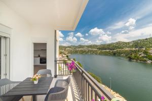 a balcony with a view of a river at Lakeview Apartments in Ploče