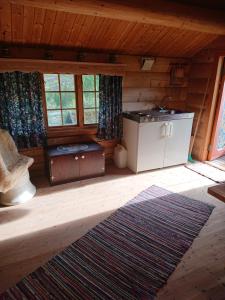 a living room of a log cabin with a stove at Marken in Hjartdal