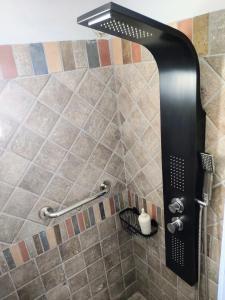a shower with a black shower head in a bathroom at #Roof(pool)garden Private in Pikérmion