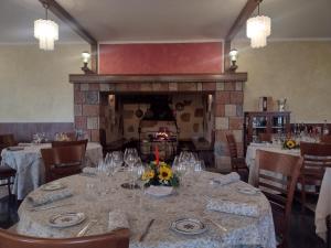 a dining room with a table and a fireplace at Parc Hotel Casa Mia in Lazise