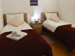 a hotel room with two beds with towels on them at Vicenza City Apartments 3 in Vicenza