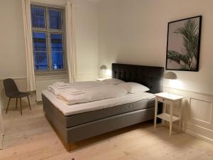 a bedroom with a bed and a table and a chair at City Center Apartments 870 in Copenhagen