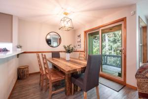 a dining room with a wooden table and chairs at Arrowhead Point by Outpost Whistler in Whistler