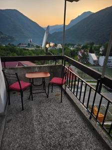 a table and two chairs on a balcony with a view at Linden apartment in Pluzine