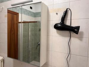 a shower with a black phone hanging on a wall at Vicenza City Apartments 3 in Vicenza +16 photos