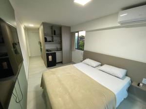 En eller flere senge i et værelse på Flat mar Porto de Galinhas