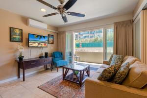 a living room with a couch and a desk at 2 Bedroom Kapaa Condo, Pool, AC, Beach Access KK116 in Kapaa