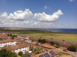 an aerial view of a town with houses and the ocean at parking inc 3 bed 15 percent off for monthly stays in Westoe