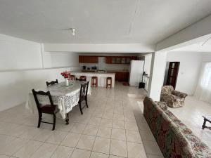 a kitchen and dining room with a table and chairs at Thomas Apartment Inc in Kingstown