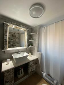 a bathroom with a sink and a mirror at Vasileris Home in Moúdhros +12 photos