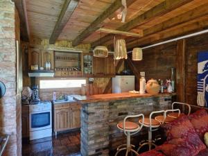 a kitchen with a stone counter and a stove at Vikendica Una in Kostajnica