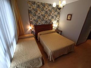 Postel nebo postele na pokoji v ubytování La Estrada