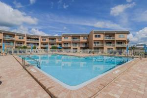 a large swimming pool in front of a hotel at Creston House 6E in St. Augustine