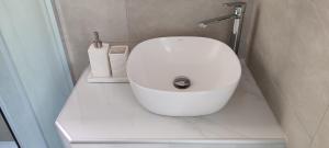 a white toilet in a bathroom with a sink at Theasis Limnos - 1st floor suite in Agios Ioannis Kaspaka +11 photos