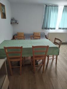 un comedor con mesa, 2 sillas, mesa y sillas en Apartment Jalen, en Bohinjska Bela