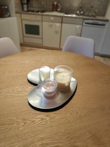 a wooden table with two glasses of food on a plate at Central Serviced Apartments in Engelberg