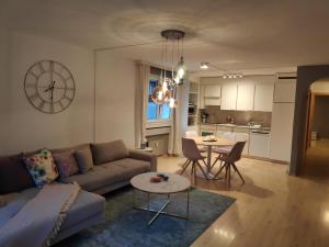a living room with a couch and a table at Central Serviced Apartment in Engelberg