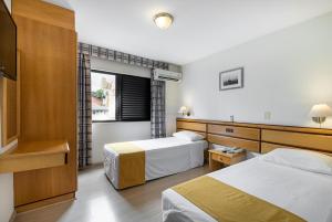 Postel nebo postele na pokoji v ubytování Hotel Flat Petras Residence