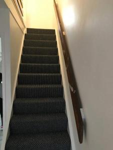 a flight of stairs in a building at East Lodge - Spacious 4 bed house in Basildon