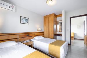 Postel nebo postele na pokoji v ubytování Hotel Flat Petras Residence