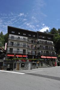 a large building with flags on the front of it at Hotel Etoile De Neige in Valtournenche